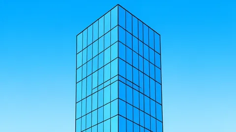 A modern glass skyscraper reflecting a clear blue sky