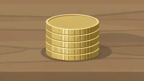 A stack of metallic coins resting on a wooden desk surface