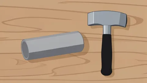A geological core sample lying on a wooden table next to a geological hammer
