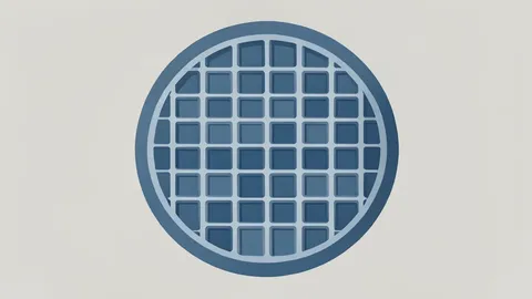 A close-up view of a silicon wafer with a grid of square integrated circuits