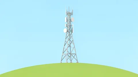 A telecommunications antenna tower standing on a grassy hill against a clear sky