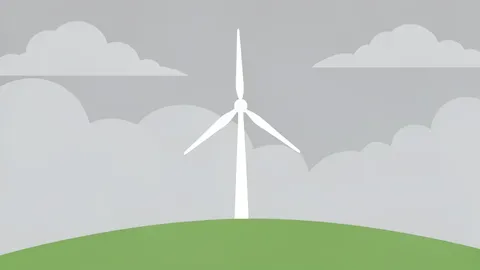 A wind turbine standing on a grassy hillside under a cloudy sky