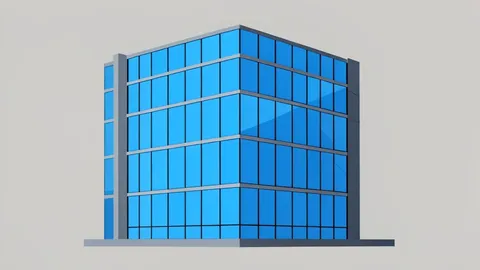 A modern glass office building facade with reflections of a clear blue sky