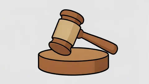 A gavel resting on a wooden sound block