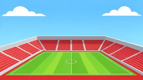 A wide-angle view of a multi-sport stadium with red running tracks and green athletic fields under a clear blue sky.