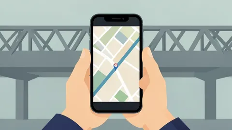 A hand holding a smartphone displaying a map route, with a blurred highway overpass in the background.