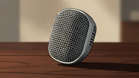 A vintage radio microphone sitting on a wooden desk