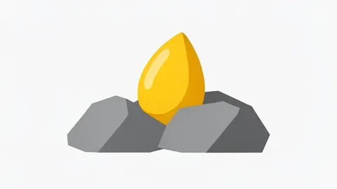 A golden nugget resting on rough grey rock