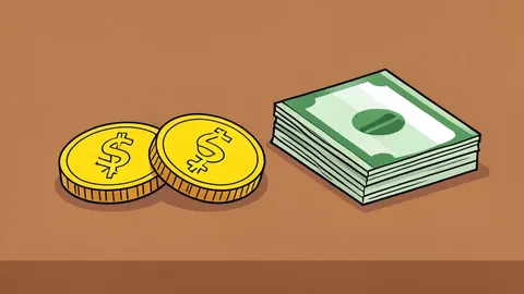 A pair of gold coins resting on a wooden desk next to a stack of paper currency