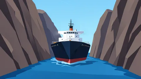 A large oil tanker navigating through a narrow strait between rocky cliffs