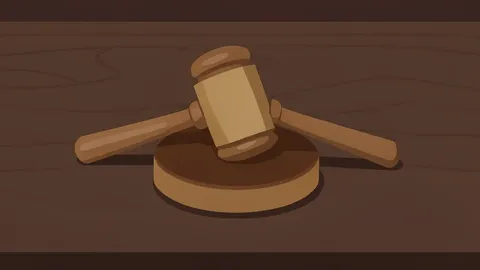 A wooden gavel resting on a dark oak desk surface