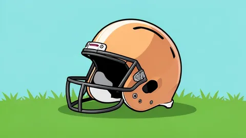 A football helmet resting on a grass field