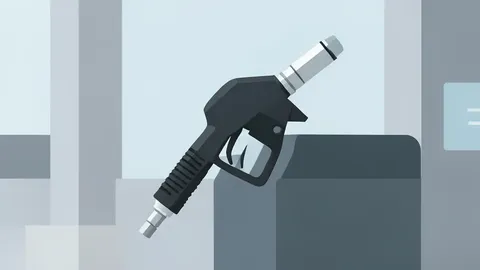 A fuel pump nozzle resting in its holster at a gas station