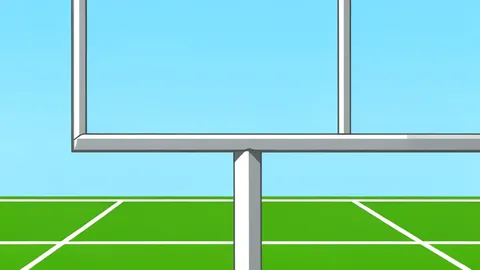 A wide-angle view of a green football field with white yard lines stretching toward a distant stadium structure.