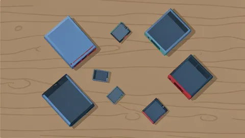 A collection of physical video game cases and cartridges resting on a wooden desk