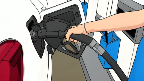 A fuel pump nozzle resting on a concrete island at a service station