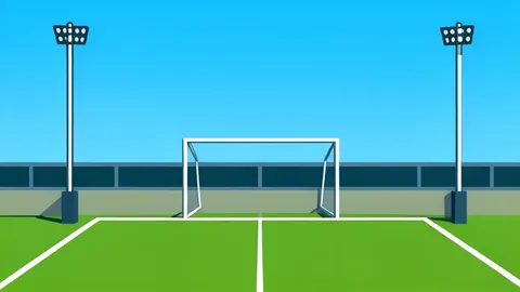 A football stadium pitch with goalposts under a clear sky
