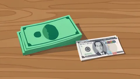 A stack of US dollar bills and a Japanese yen note resting on a wooden desk