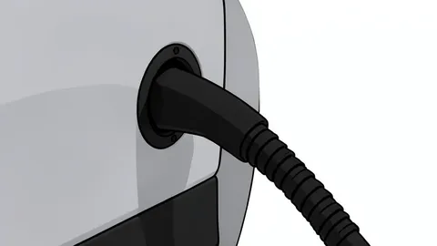 A modern electric vehicle charging station with a cable plugged into a car