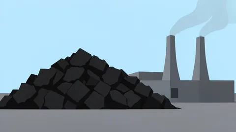 A massive pile of black coal in an open-air storage yard next to a power plant