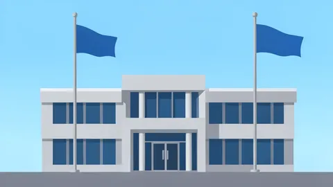 A modern government office building with a secure entrance and flagpoles