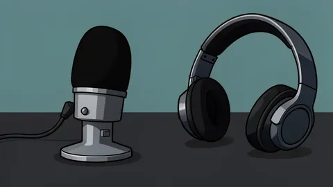 A vintage radio microphone with a foam windscreen sits on a wooden desk next to a pair of headphones.