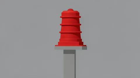 A red civil defense siren mounted on a concrete pole against a grey sky