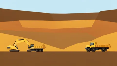 An open-pit gold mine with terraced earth walls and heavy mining machinery