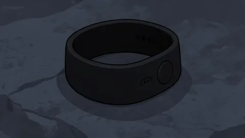 A sleek, screen-free wristband with a single button and a small speaker grille, resting on a wooden surface next to a smartphone.