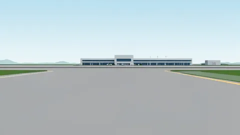 A wide expanse of grey airport tarmac stretching toward a distant terminal building under a hazy sky