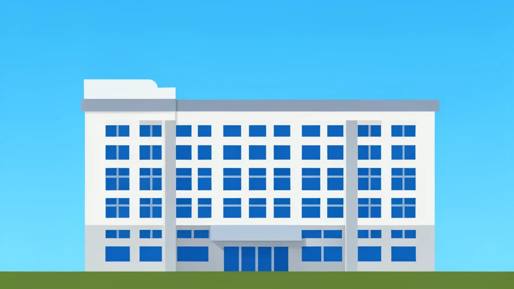 A large, multi-story office building with a flat roof and rows of uniform windows, standing alone against a clear sky.