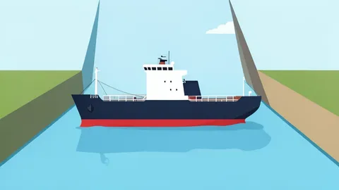 A large oil tanker ship moving through a narrow strait