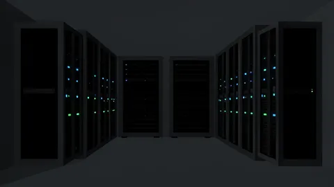 Rows of black server racks with blinking status lights in a dimly lit data center aisle