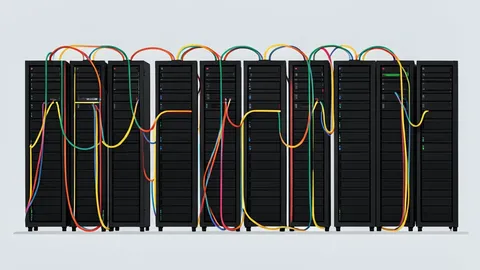 A cable television headend room with rows of black server racks and fiber optic cables