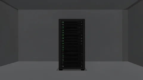 A single server rack standing alone in a dark, empty data center room.