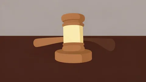 A wooden gavel resting on a dark mahogany desk surface.