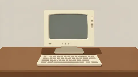 A vintage beige computer monitor and keyboard sitting on a wooden desk surface