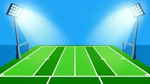 A green football field with white yard lines under bright stadium floodlights
