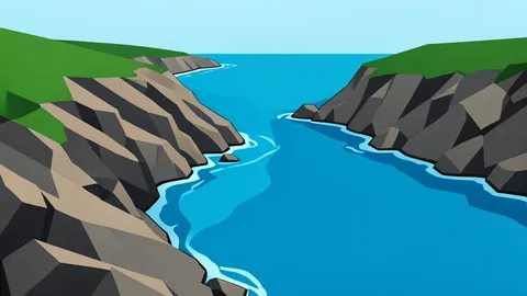 A rocky coastline meeting the sea near a narrow strait