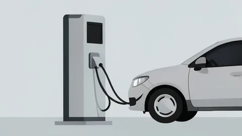 A modern electric vehicle charging station with a cable plugged into a car
