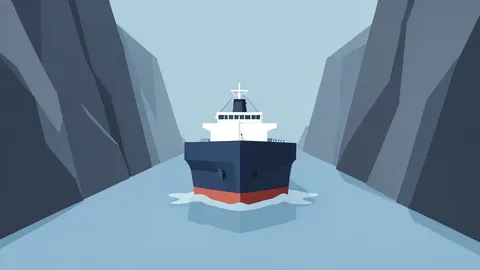 A large oil tanker ship moving through a narrow strait