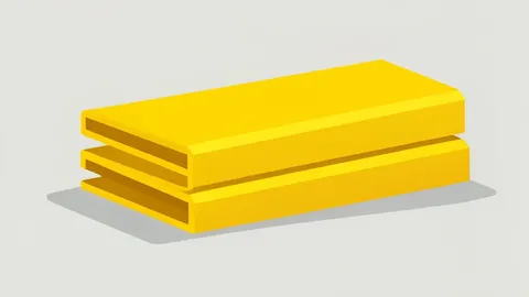 A neat stack of gleaming yellow metal bars on a plain surface.