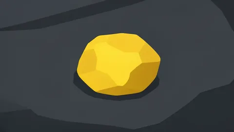 A rough, unrefined nugget of yellow metal resting on a dark stone surface