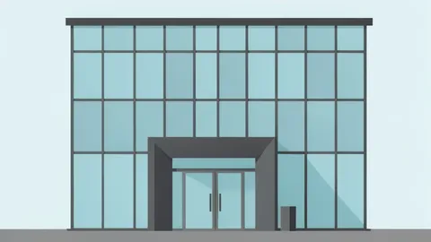 A modern office building with a glass facade and a lobby entrance