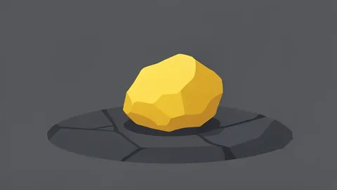 A rough, unrefined nugget of gold resting on a dark stone surface