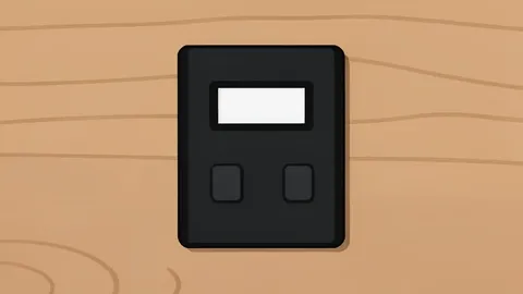 A matte-black hardware wallet with a small monochrome screen and buttons sits on a wooden desk.