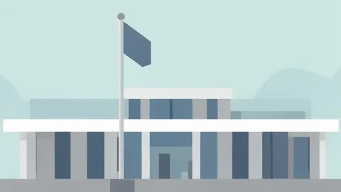 A modern government ministry building with a flagpole