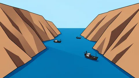 A narrow, deep-water strait connecting two large bodies of water, with steep, arid cliffs rising on either side and a few small fishing boats navigating the channel.