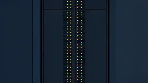 A dark server rack with blinking status lights in a data center