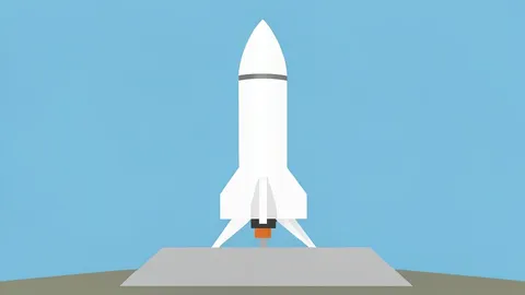 A white rocket standing vertically on a concrete launch pad